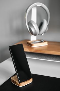 an iphone and headphones on a desk