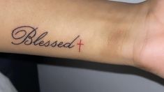 a person's arm with a tattoo that says, blessed and a cross on it