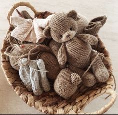 a basket filled with knitted teddy bears and mittens