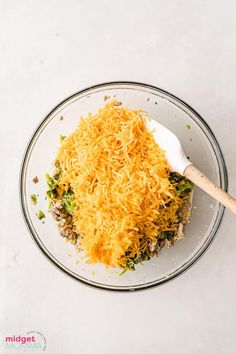 a glass bowl filled with cheese and other food