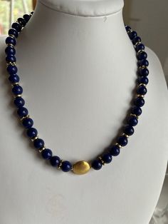 Dark blue gemstone necklace made of lapis lazuli beads with gold center bead, gold-colored intermediate beads and gold-colored design magnet. The beads are strung on tear-resistant, nylon-coated jewelry wire and have a chain length of 45 cm. As a birthstone, lapis represents the zodiac signs Virgo and Aquarius. As a healing stone, it stands for truthfulness. It is intended to promote open and honest discussion, criticism and friendship. Good for the throat, larynx and vocal cords. Celtic Jewellery, Vocal Cords, Blue Gemstone Necklace, Magnet Design, Zodiac Signs Virgo, Virgo And Aquarius, Lapis Lazuli Beads, Pretty Jewelry, Jewelry Wire