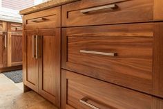 a kitchen with wooden cabinets and tile flooring