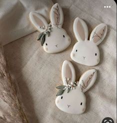 three decorated cookies are sitting on a table