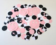 a pile of pink and black polka dots with the number 5 on them in front of a white background