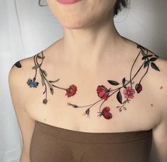 a woman with flowers on her chest is smiling