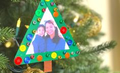 an ornament shaped like a christmas tree with two people on it