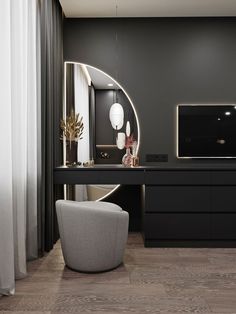 a black and white living room with a large mirror on the wall next to a desk