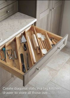 an open drawer with utensils in it