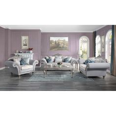 a living room filled with furniture and purple walls