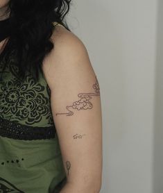 a woman with a tattoo on her arm