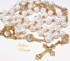 White Faceted Pearl Catholic Rosary. Features Swarovski AB crystal beads  Luminous white, 6mm faceted crystal pearls make up the Ave beads. Each crystal pearl starts with a crystal base, and has thick layers of real pearl nacre coating. Pearls have an elegant look, and a lustrous shimmer.  The Pater beads are 6x8mm Swarovski AB crystals, with large facets that catch and reflect the light at every angle. Beads are capped with filigree gold bead caps for an elegant touch. The ornate grapes and vin Faceted Pearl, Gold Rosary, Thick Layers, Holy Rosary, Catholic Rosary, Sparkling Clean, Rosary Catholic, Real Pearls, Storage Pouch