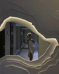 a woman in a white dress is taking a selfie with her cell phone through a mirror