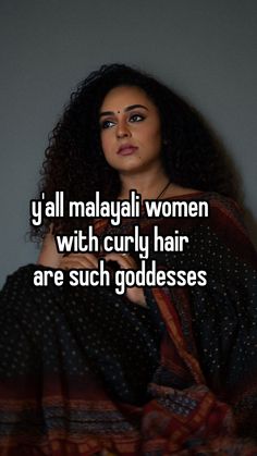 a woman with curly hair wearing a sari