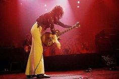 two people on stage with guitars in their hands