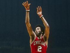 a basketball player is reaching up to dunk the ball with his hands in the air