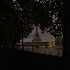 the eiffel tower is lit up at night