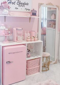 a pink and white room with an old fashioned refrigerator