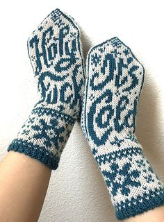 two hands wearing mittens with blue and white designs