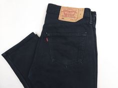 Free shipping for two or more items. Add to cart and check. Vintage Levi's 501 jeans 1990s, black Color. Made in UK(Europe), Factory 299,  1999'. FABRIC: 100% cotton denim SIZE on tag: 32 x 30.  Please refer to measurements: Waist: 31 inch / 79 cm Hips: 43 inch / 109 cm Thigh: 22 inch / 57 cm Inner length: 30 inch / 76 cm Outer length: 40 inch / 101 cm Leg opening: 15 inch / 38 cm Front rise: 11 inch / 28 cm Back rise: 14,5 inch / 37 cm Feel free to ask any questions. If you are looking for simi Straight Leg Levis, Levis 501 Black, Levi 501 Jeans, Streetwear Jackets, Levis Vintage, Vintage Clothing Stores, Men In Black, Vintage Sportswear, Vintage Trousers