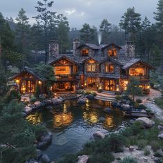 this is an aerial view of a house in the woods at night with lights on