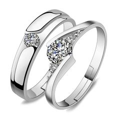 two white gold wedding rings with diamonds on each side and one diamond in the middle