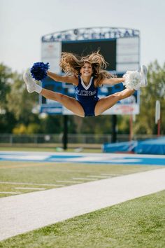 a cheerleader in mid air during a football game