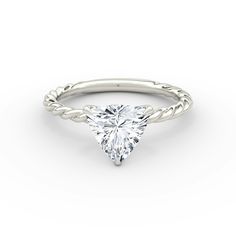 a white gold engagement ring with a pear shaped diamond in the center and twisted band