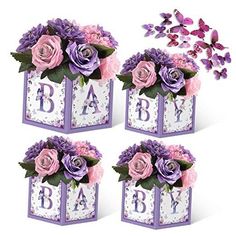 purple and pink flowers are in the center of three baby blocks