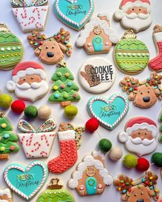 many decorated christmas cookies on a table