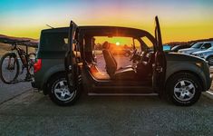 a car with the door open sitting in a parking lot