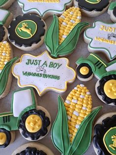 decorated cookies are arranged in the shape of tractors and corn on the cob with words just a boy