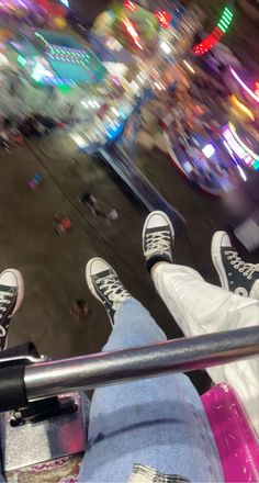 two people are sitting on a carousel at night