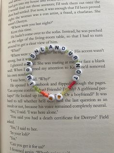 an open book with some beads on it