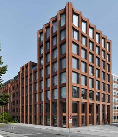 the building has many windows and is made out of red bricks with white trims