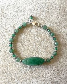 Gorgeous green adventurine carved beads are accompanied by smooth and faceted green adventurine beads and highlighted by silver plated spacer beads in a length of 7.75 inches (this can be shortened if desired). Green Jade Beaded Bracelets With Polished Beads, Green Gemstone Beaded Bracelets With Oval Beads, Silver Jade Beaded Bracelets, Green Jade Bracelets With Faceted Beads, Vintage Green Round Beads Bracelet, Green Aventurine Beaded Bracelets, Hand-strung Aventurine Beaded Bracelets, Green Aventurine Beaded Hand-strung Necklace, Vintage Green Faceted Beads