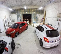 three cars are parked in a garage area