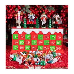 a red and green christmas themed calendar with figurines