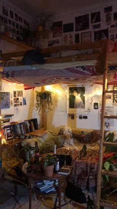 a loft bed with lots of clutter on it's sides and lights strung from the ceiling