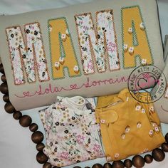 a pillow with the word mama on it next to some other items that are laid out in front of it