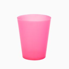 a pink cup sitting on top of a white table