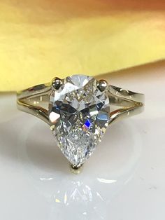 "This ring is a pear shape simulated diamond in a splint shank design made with solid 14k yellow gold item #5511 -Approximate total carat weight: 3.00ctw diamond equivalent -Center Stone Size: 12x8mm approx. 3.00ct diamond equivalent -Gem Type: simulated diamond -Stone Shape: Pear -Stone Clarity: VVS1 -Stone Color: D -Moh's Scale: 8.5 Hardness -Metal Type and Purity: 14k yellow gold -Setting: 3 prong split shank design -Stock Ring Size: 6 -Country of Manufacturing: USA (Michigan) For customizati Split Shank Pear Engagement Ring, Pear-shaped 14k Gold Rings With Accent Stones, Fine Jewelry Pear-shaped Hallmarked Rings, Pear Split Shank Ring, Vintage Hallmarked Pear-shaped Rings, Pear Solitaire Ring, Pear Shape Engagement Ring, Wedding Ring Pear, Engagement Ring Split Shank