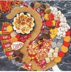 a platter filled with assorted candy and snacks