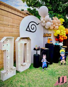 an outdoor birthday party with balloons and decorations