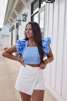 Make a statement with this gorgeous blue ruffle top! Featuring a square neckline with a slightly cropped waist, smocked back with zipper closure, back tie strap, and ruffled puff sleeves. 100% cotton model is 5'4 with a 34" bust and is wearing a small. runs true to size Wrap Crop Top Outfit, Ruffle Shoulder Top, Blue Ruffle Top, Ruffle Crop Top, Wrap Crop Tops, Closet Inspiration, Crop Top Outfits, Neck Crop Top, Ruffle Sleeves