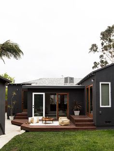 a modern house with an outdoor deck and patio