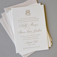 the wedding stationery is laid out on top of each other