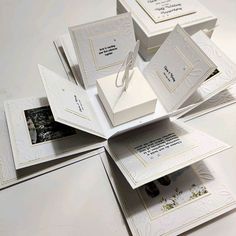 several white cards are stacked on top of each other with the same design in them