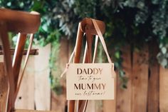 a wooden chair with a sign hanging from it's back that says daddy there is no mommy