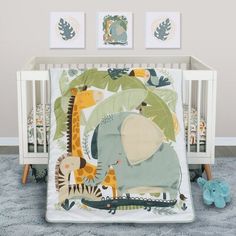 a baby crib bedding set with an elephant and giraffe