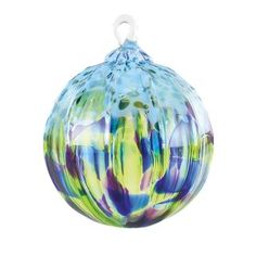 a colorful glass ornament sitting on top of a table